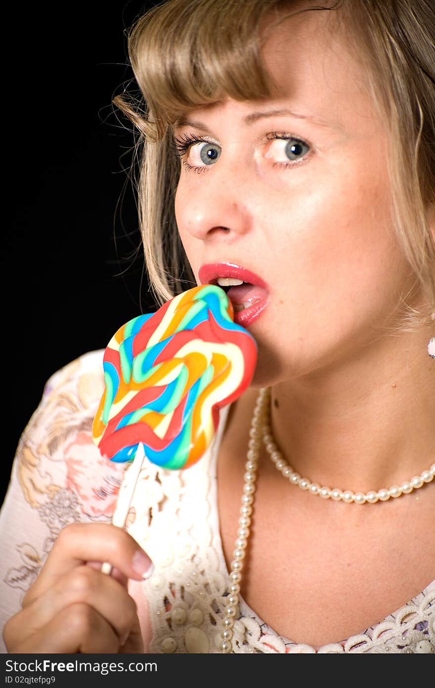 Women licking lollypop , vintage stile, black background. Women licking lollypop , vintage stile, black background