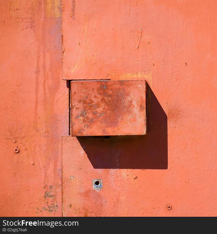 Keyhole in the old red metal door. Keyhole in the old red metal door