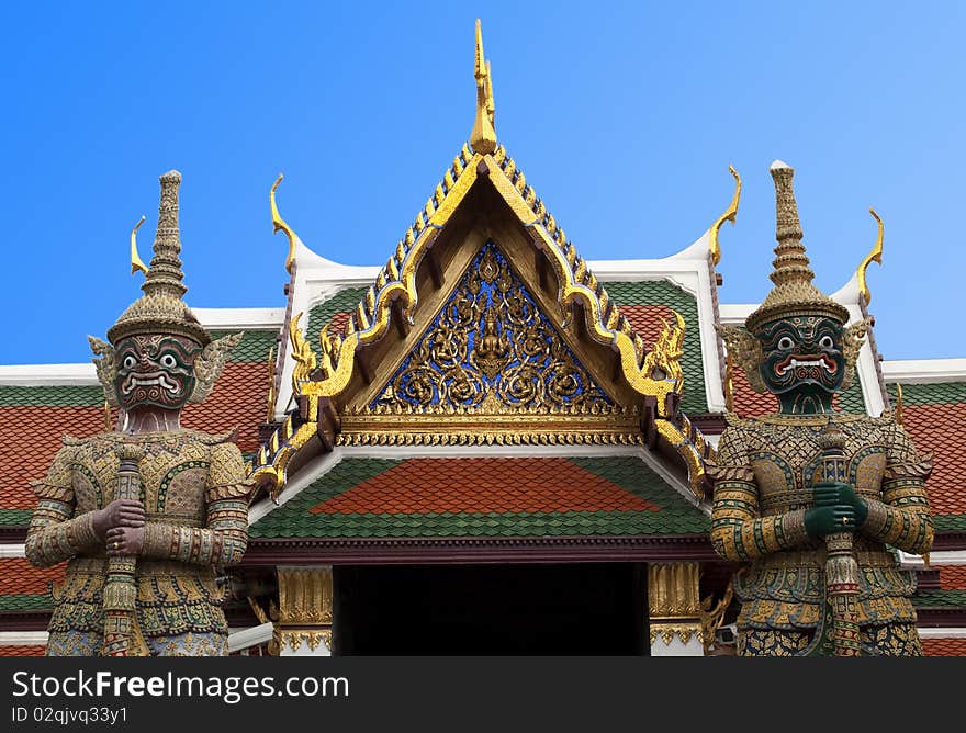 The giant guardians with anger face at The Emerald Buddha Temple in Bangkok, Thailand. The giant guardians with anger face at The Emerald Buddha Temple in Bangkok, Thailand.