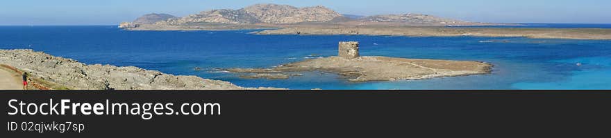 Long horizontal panorama of beautiful La Pelosa Beach near Stintino in Sardinia, Italy;
Rocky coast, island with remains of a tower, shallow turquoise waters and tourist resort; across the bay, Asinara island Tourists, swimmers, sailing boats, pedaling boats, motorboats in the water. Long horizontal panorama of beautiful La Pelosa Beach near Stintino in Sardinia, Italy;
Rocky coast, island with remains of a tower, shallow turquoise waters and tourist resort; across the bay, Asinara island Tourists, swimmers, sailing boats, pedaling boats, motorboats in the water