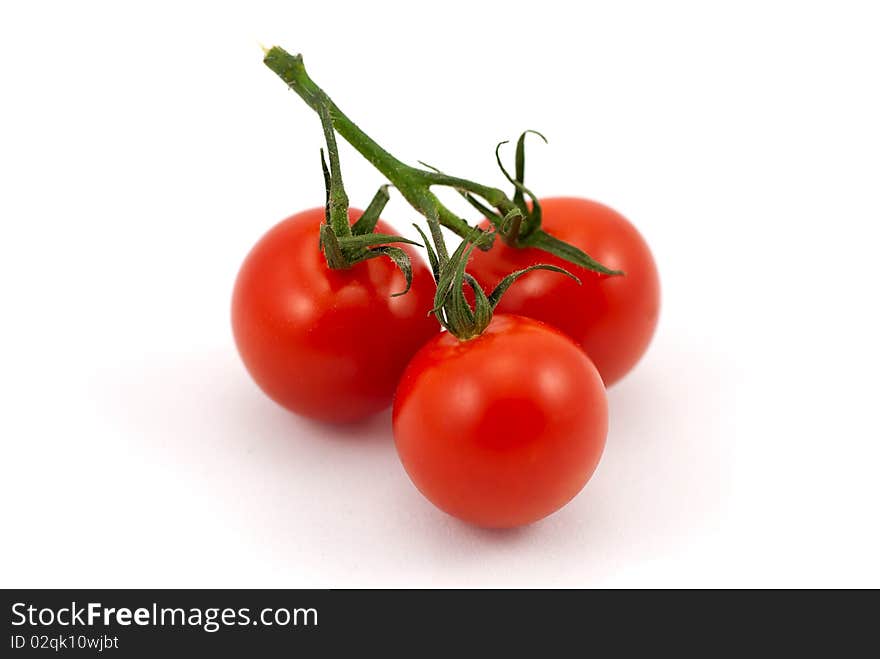 Close up of red tomatoes isolated over white.