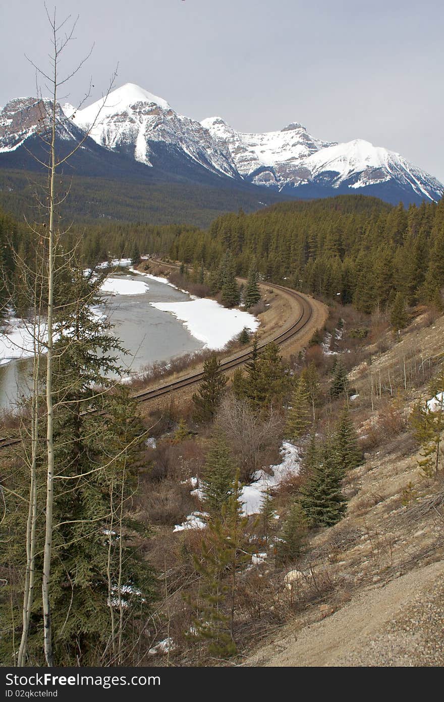 A mountain railway next to a river in Banff national park. A mountain railway next to a river in Banff national park.