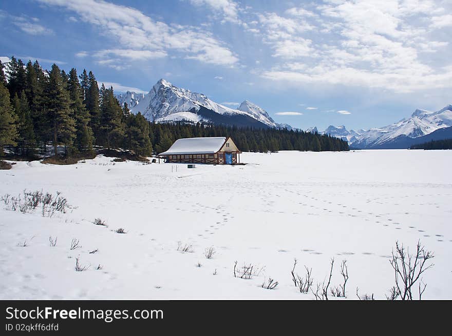 A frozen lake and cabin covered in snow. A frozen lake and cabin covered in snow.