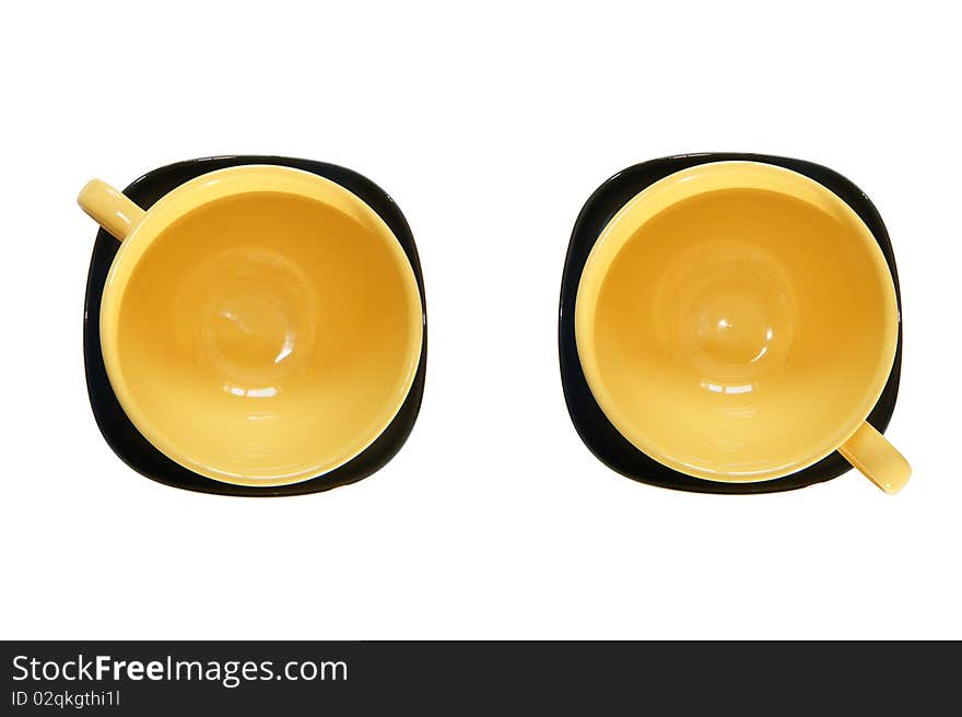 Yellow cup and black saucer, top view