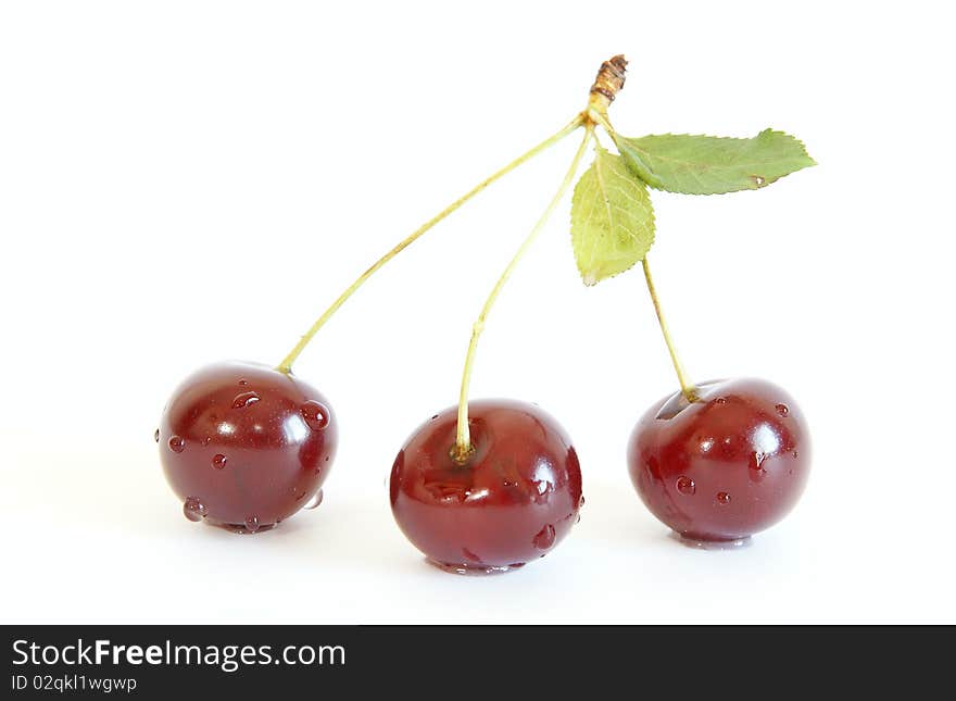 Fresh bright red cherry closeup, isolated on a white background. Fresh bright red cherry closeup, isolated on a white background