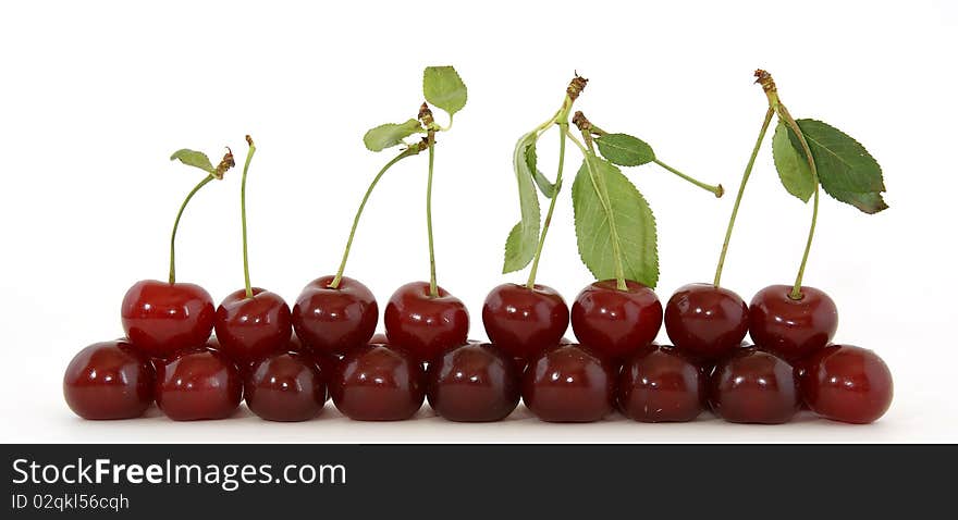 Fresh bright red cherry closeup, isolated on a white background. Fresh bright red cherry closeup, isolated on a white background