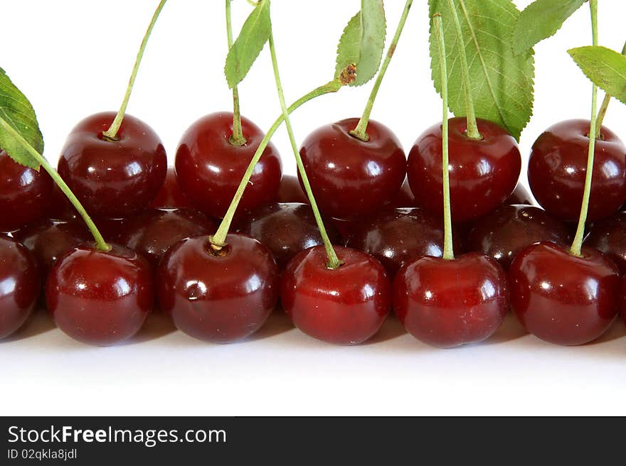 Fresh bright red cherry closeup, isolated on a white background. Fresh bright red cherry closeup, isolated on a white background