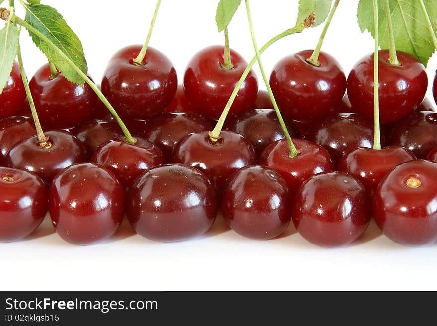 Fresh bright red cherry closeup, isolated on a white background. Fresh bright red cherry closeup, isolated on a white background