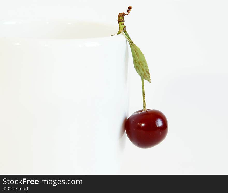 Fresh bright red cherry closeup, isolated on a white background. Fresh bright red cherry closeup, isolated on a white background