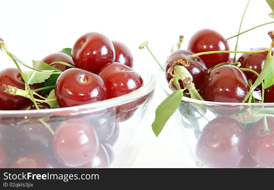 Fresh bright red cherry closeup, isolated on a white background. Fresh bright red cherry closeup, isolated on a white background