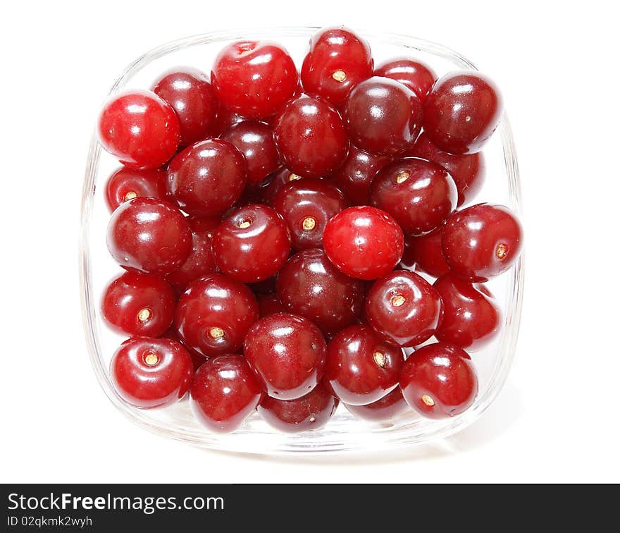 Fresh bright red cherry closeup, isolated on a white background. Fresh bright red cherry closeup, isolated on a white background