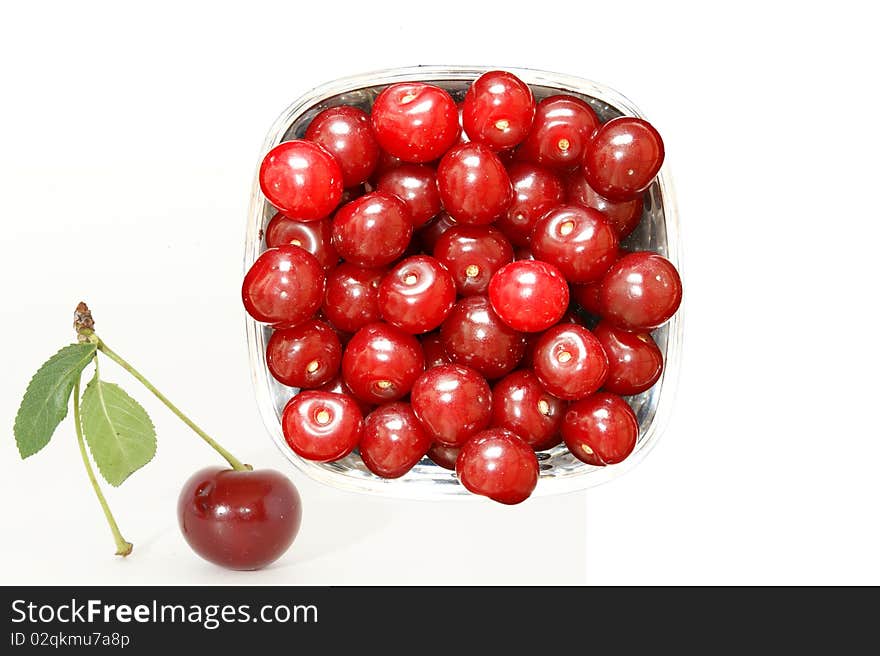 Fresh bright red cherry closeup, isolated on a white background. Fresh bright red cherry closeup, isolated on a white background