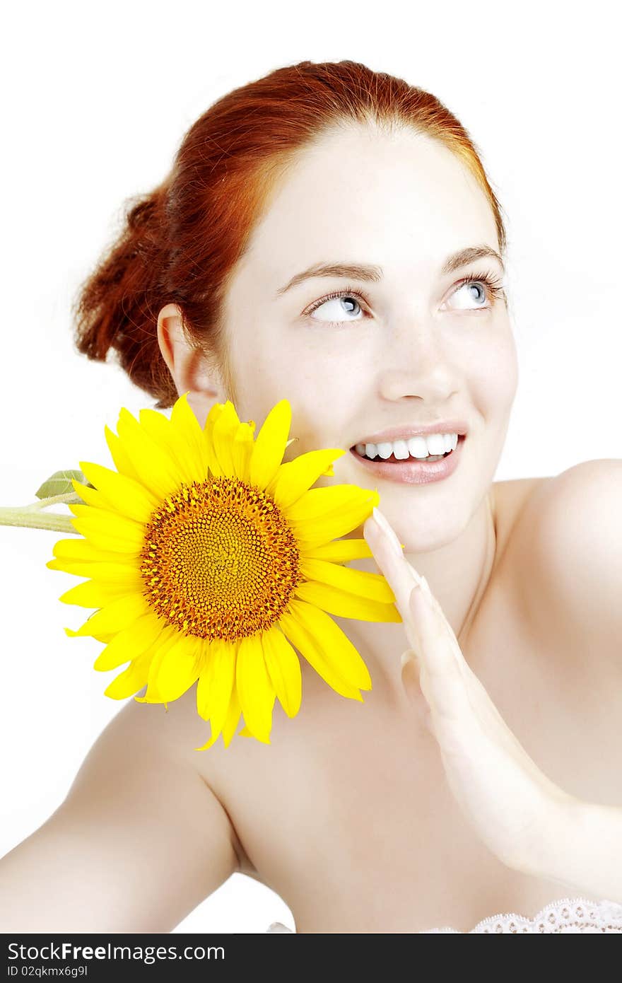 Smiling girl with a sunflower in the hands