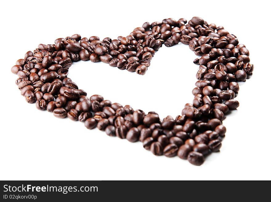 Coffee beans in the shape of a heart, closeup on white background