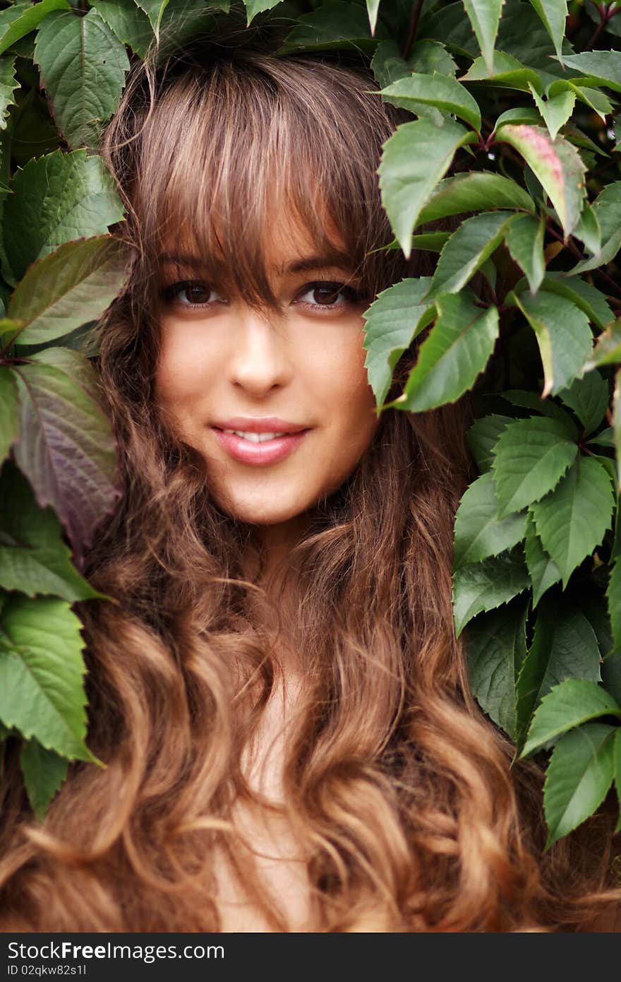 Portrait of the girl in green foliage