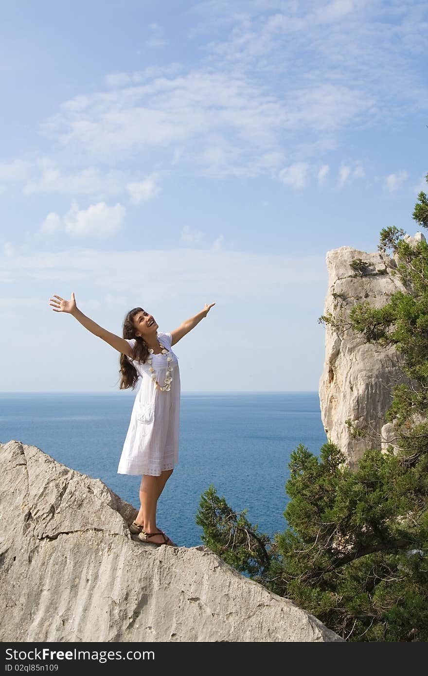 Happy young girl on the rocks