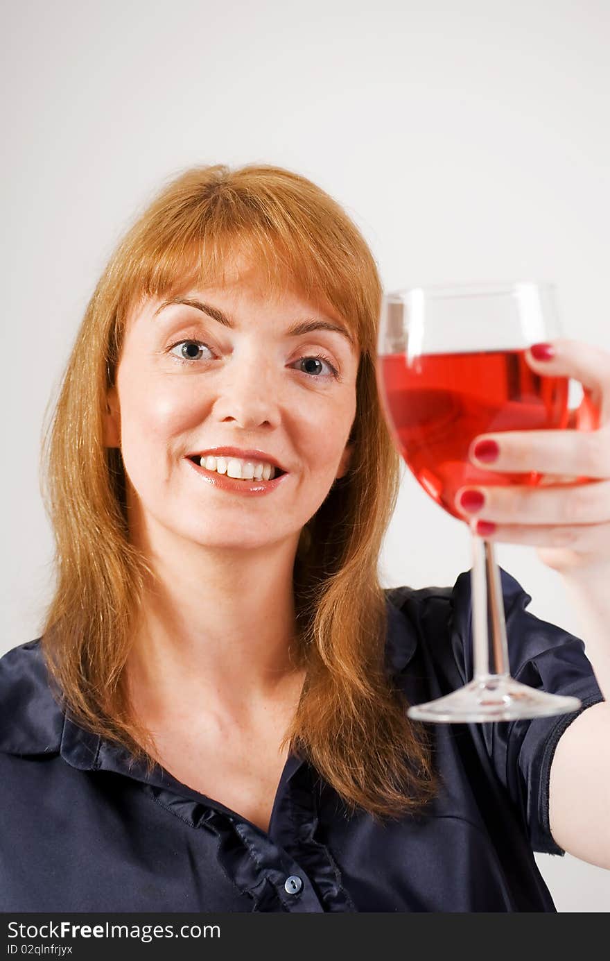 Woman Toasting With Glass Of Red Wine