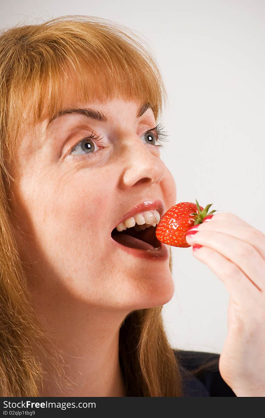 Woman eating strawberry