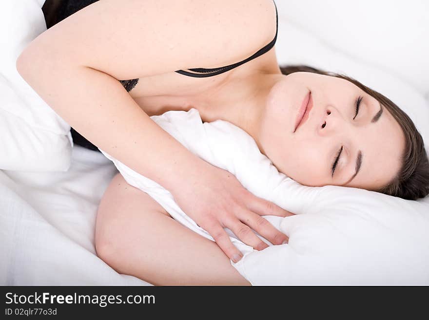 Young adult woman sleeping in bed. Young adult woman sleeping in bed