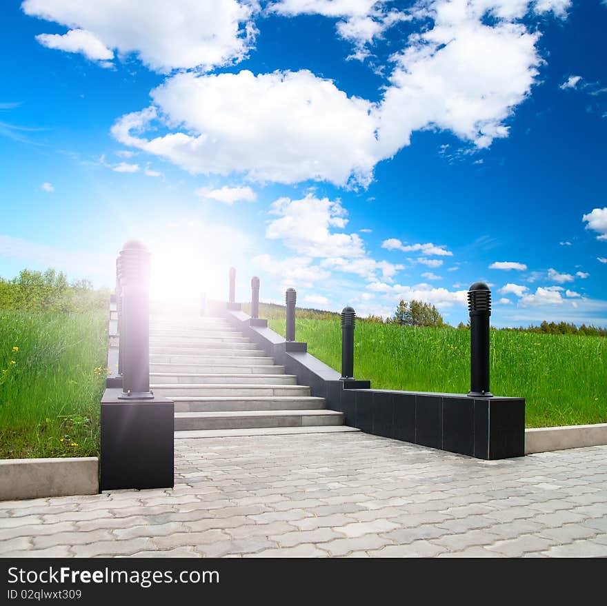 Marble front staircase in green park under blue sky