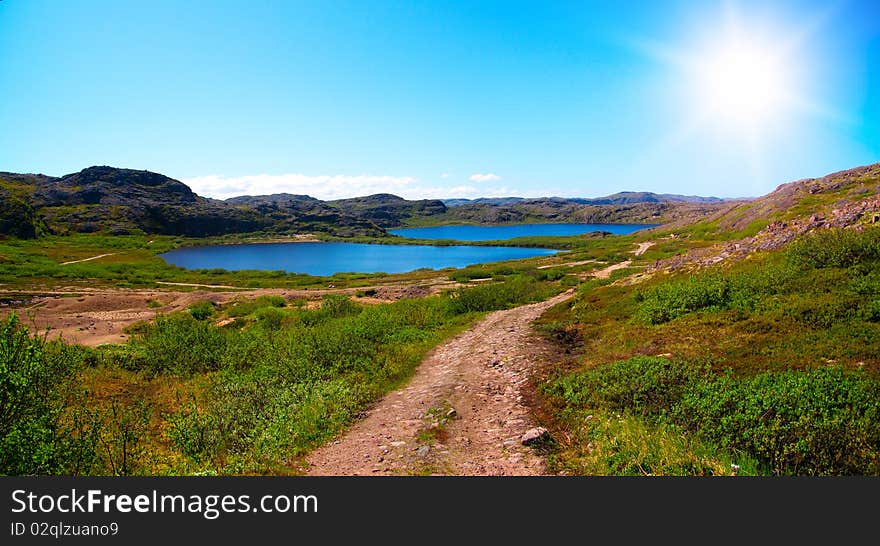 Two lakes surrounded by green hill. Coast of Kola Peninsula. Teriberka.