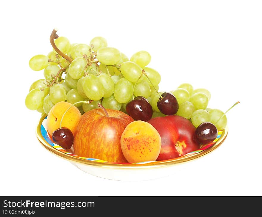 Various fruit in a bowl on a white background