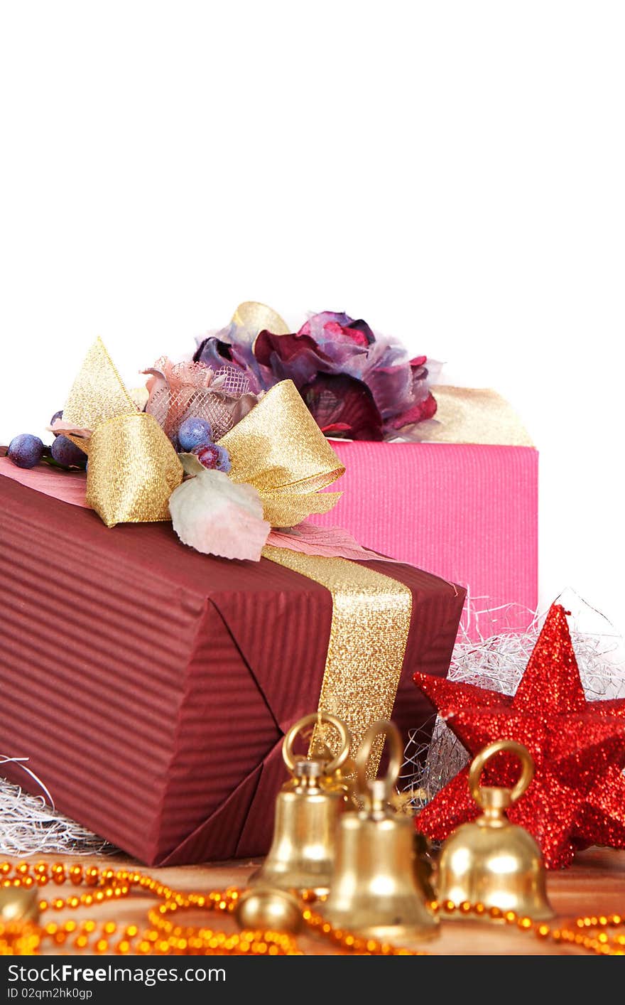 Close-up view of Christmas presents and ornaments over white background with copyspace