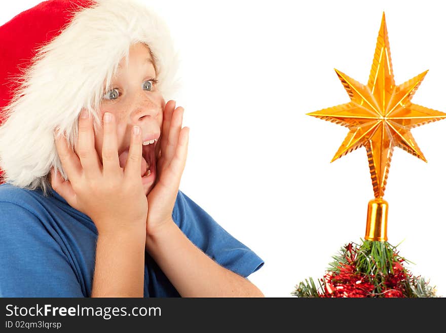 Young boy is excited while looking at Christmas tree with copyspace. Young boy is excited while looking at Christmas tree with copyspace