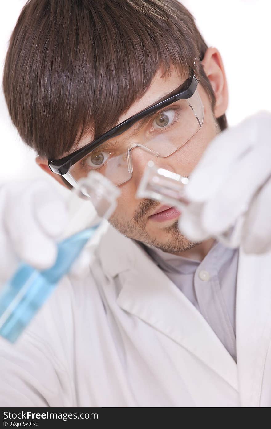 Scientist with two flasks