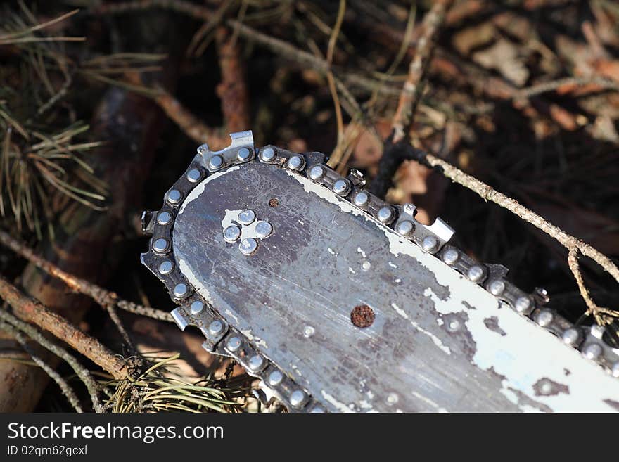 Chain saw against firewood pile. Chain saw against firewood pile.