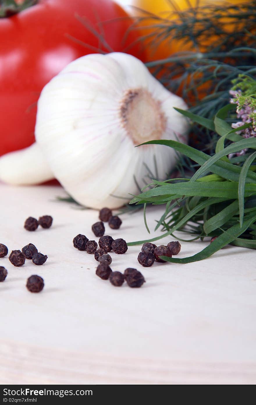 Close up of black peppercorns against vegetables