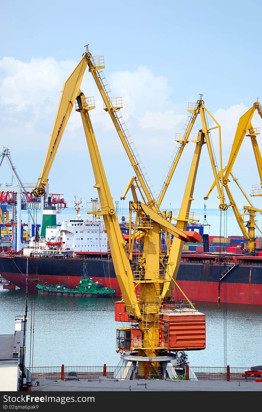 The trading seaport with cranes, cargoes and ship