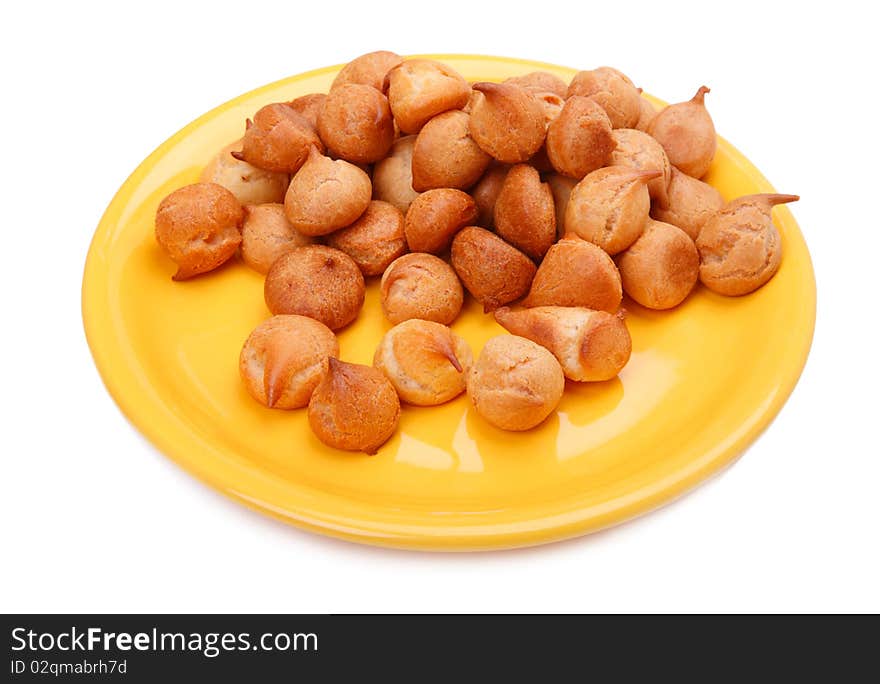 Small white bread on a yellow plate isolated on a white background. Small white bread on a yellow plate isolated on a white background