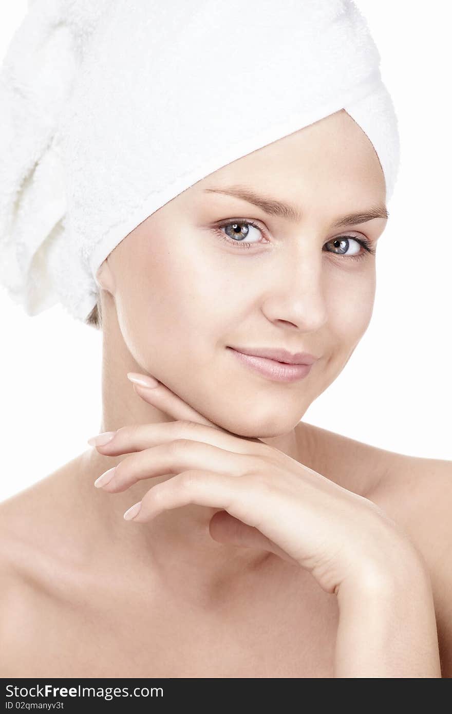 Young pretty girl in the towel on a white background