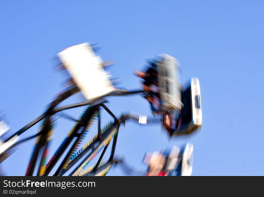 Carnival ride at fairground with blurred motion