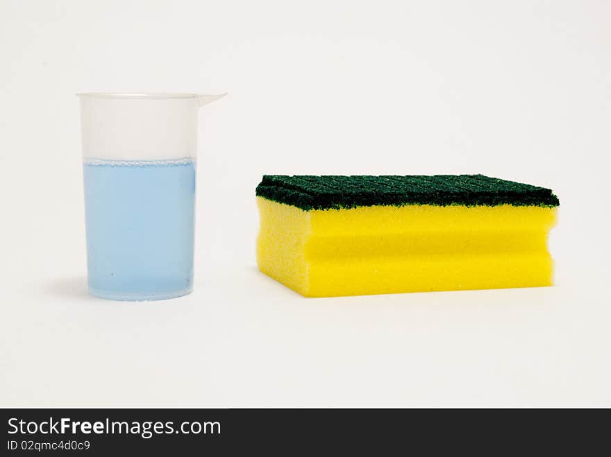 Kitchen sponge and cleaning fluid isolated foreground