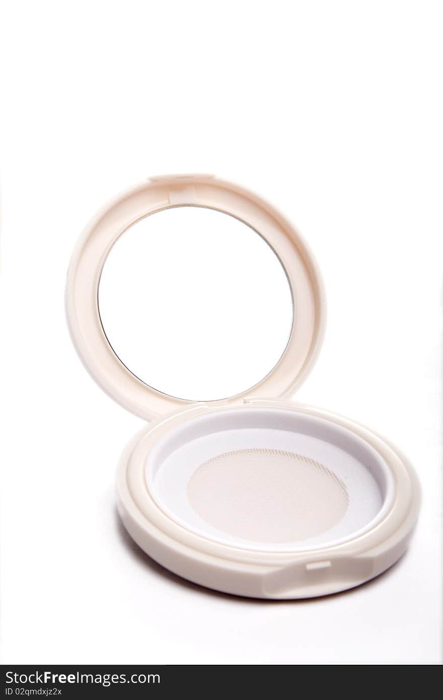 A opened cosmetic mirror on white background