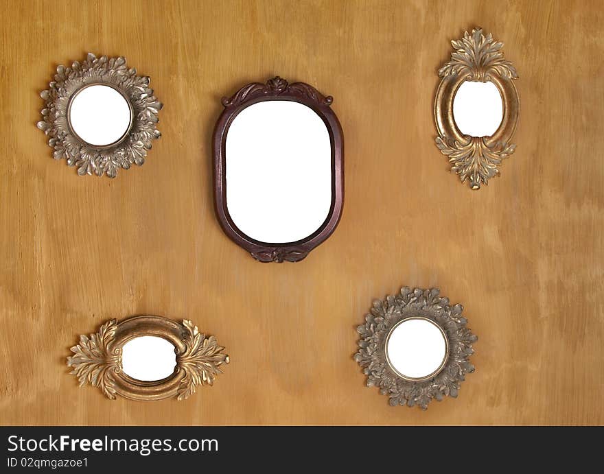 Five empty mirror frames against yellow texture wall. Five empty mirror frames against yellow texture wall