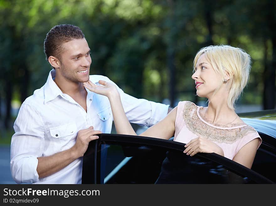 Young happy couple about cars. Young happy couple about cars