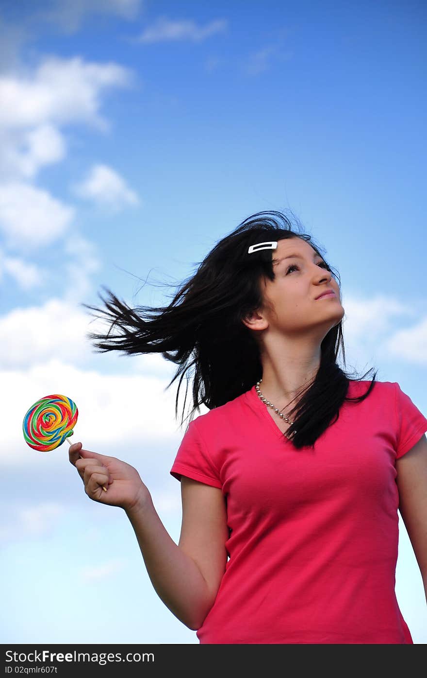 Girl with lollipop and blue sky