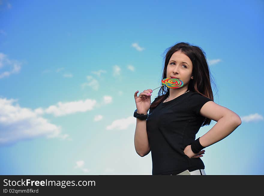 Girl with lollipop and blue sky