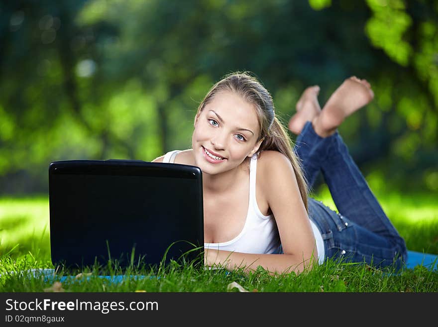 Attractive girl with a laptop in the park. Attractive girl with a laptop in the park