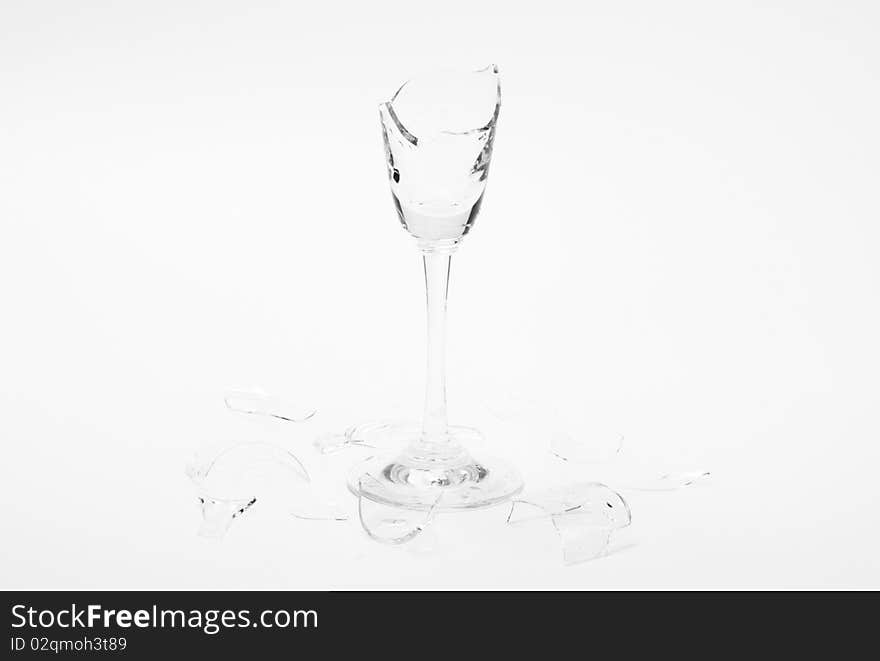 Broken wineglass on the white background. Black and white.