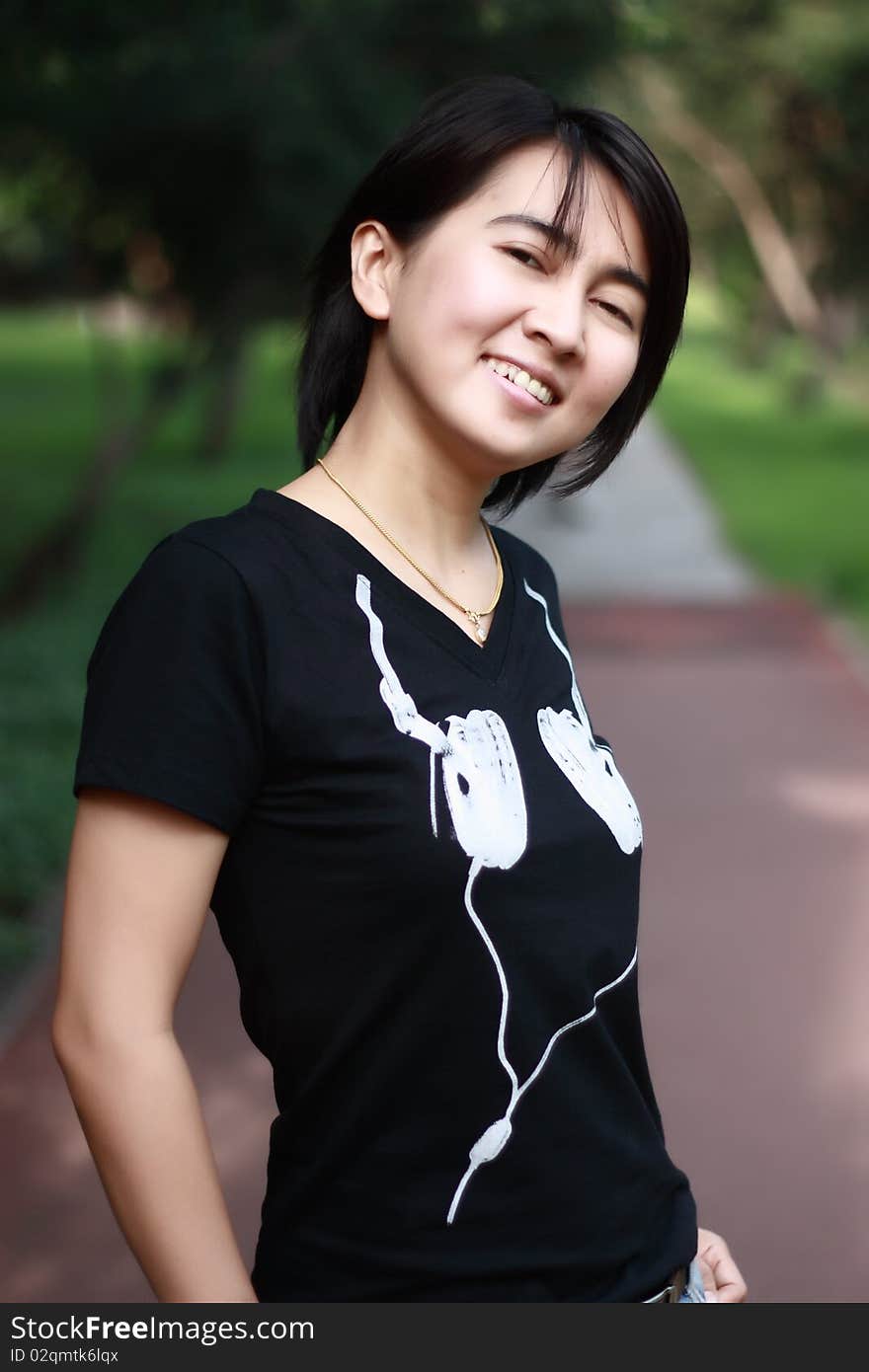 Asian woman smiling in the park