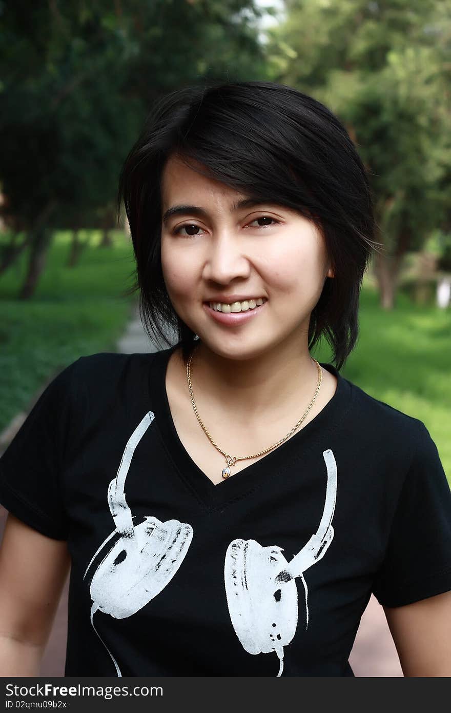 Asian Woman Smiling In The Park