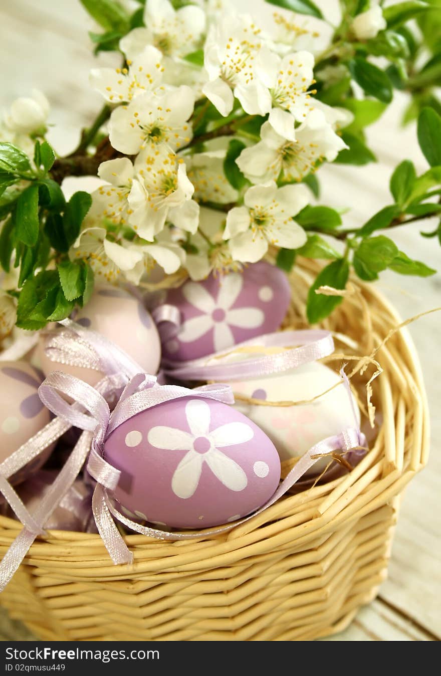 Easter eggs and branch with white flowers