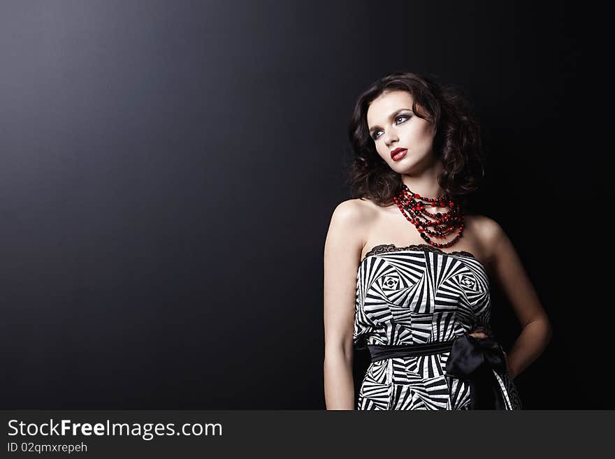 Young beautiful girl on black background