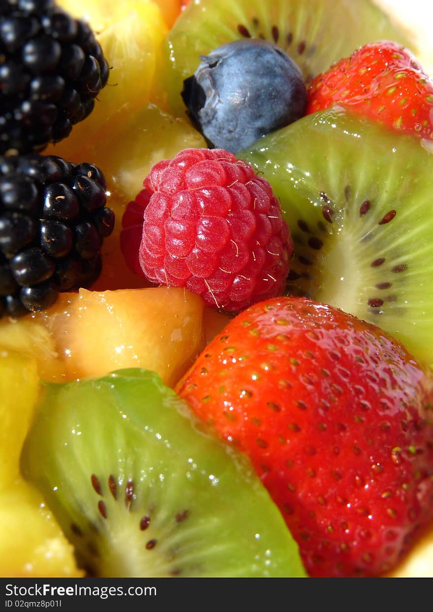 Multicolored fresh summer fruit-dessert closeup. Multicolored fresh summer fruit-dessert closeup