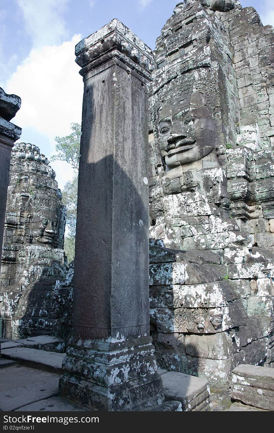 Ancient faces stone Cambodian temple Bayon