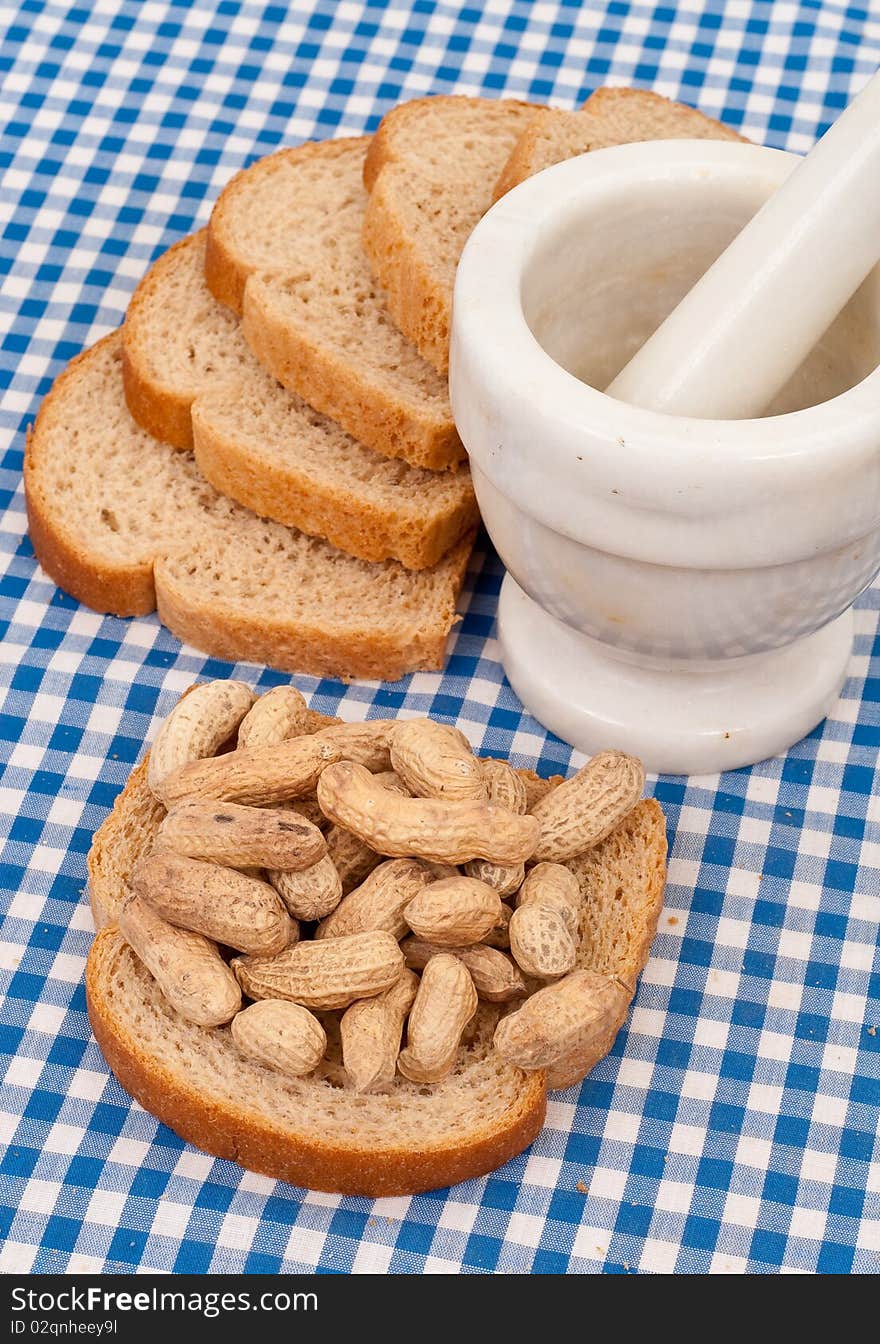 Peanuts on Wheat Bread With Mortar and Pestle. Peanuts on Wheat Bread With Mortar and Pestle